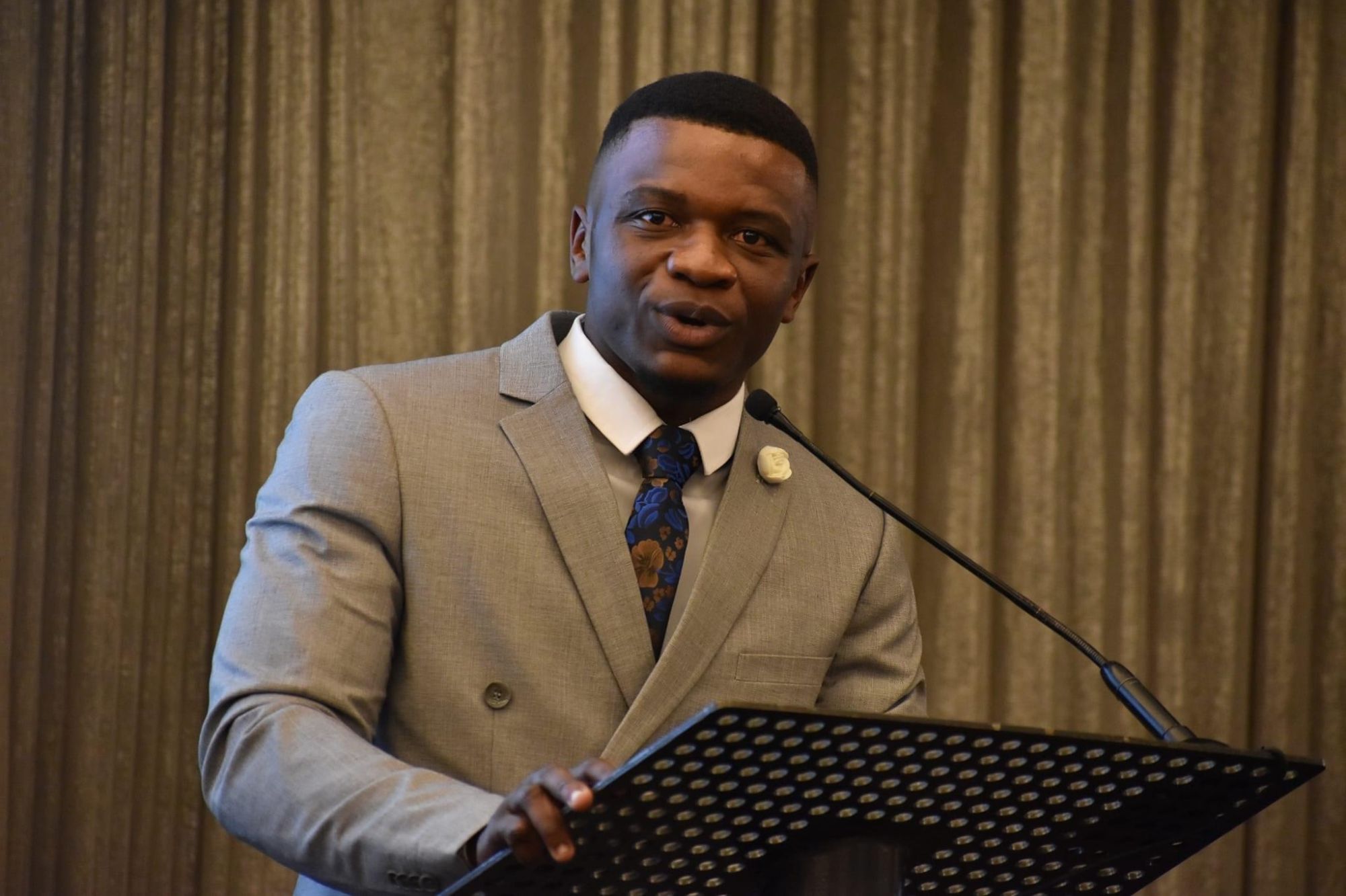 Ivyn Sambo speaking at a podium